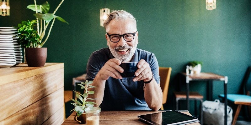 smiling man drinking coffee