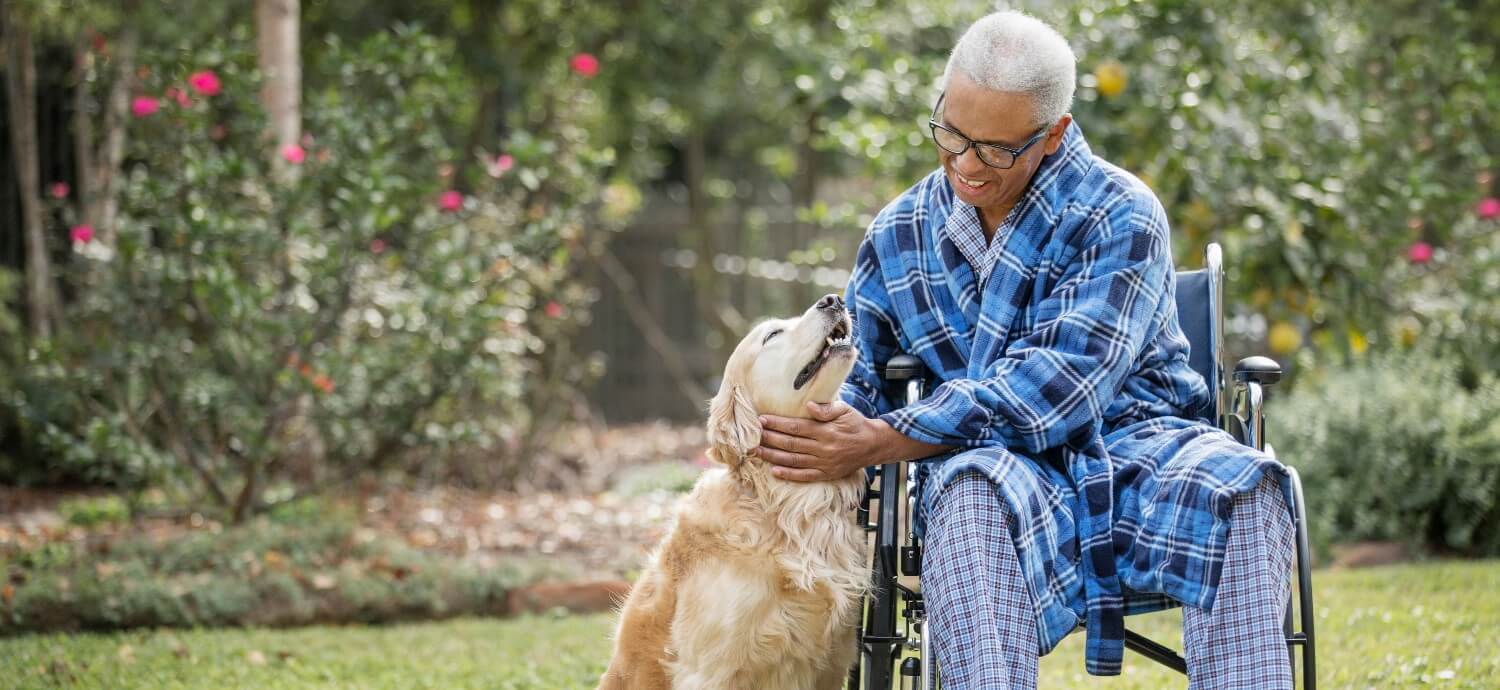 senior man in wheelchair with senior dog