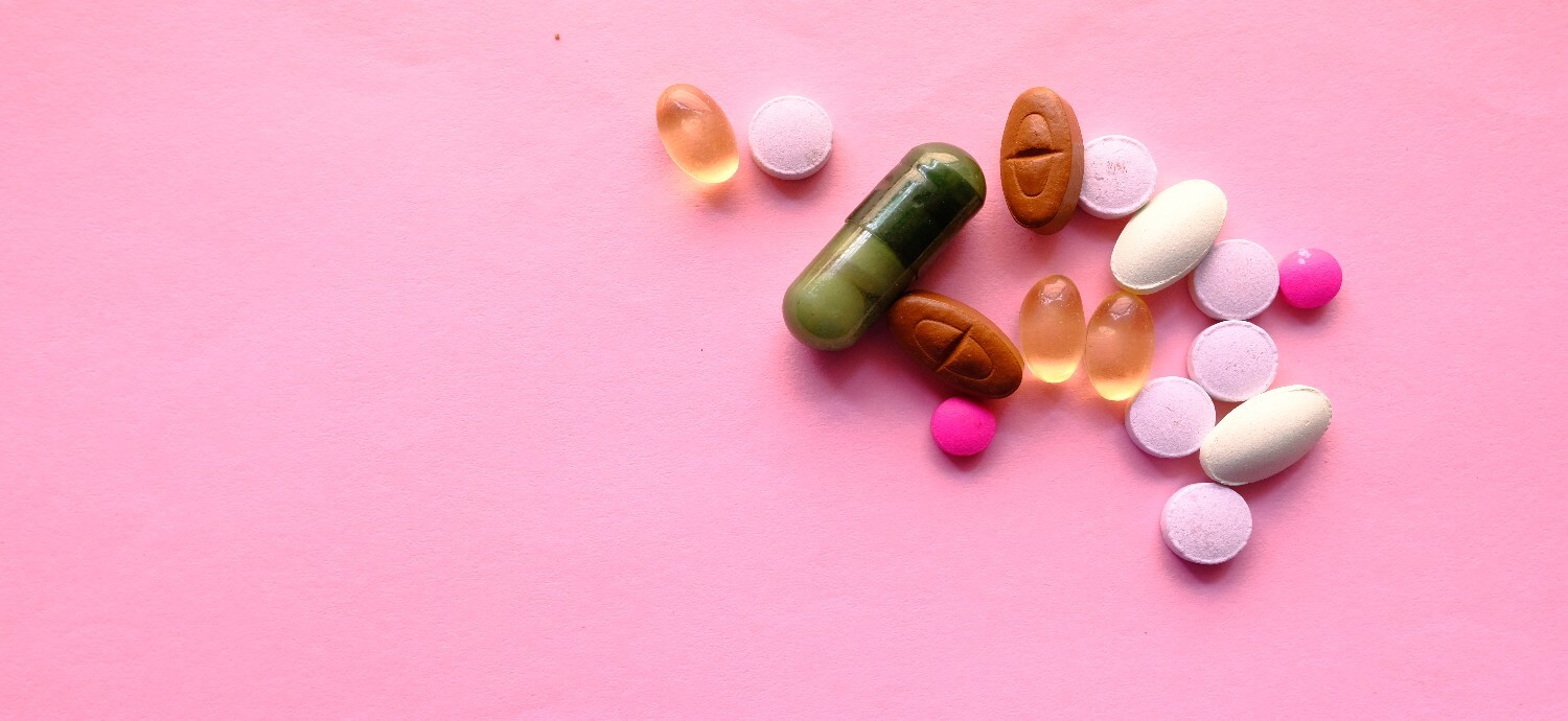 vitamins on a pink background