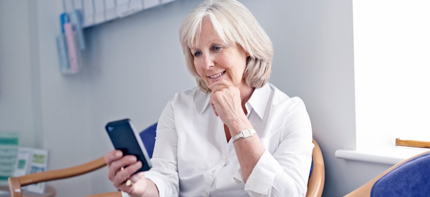 Woman reading phone in waiting room