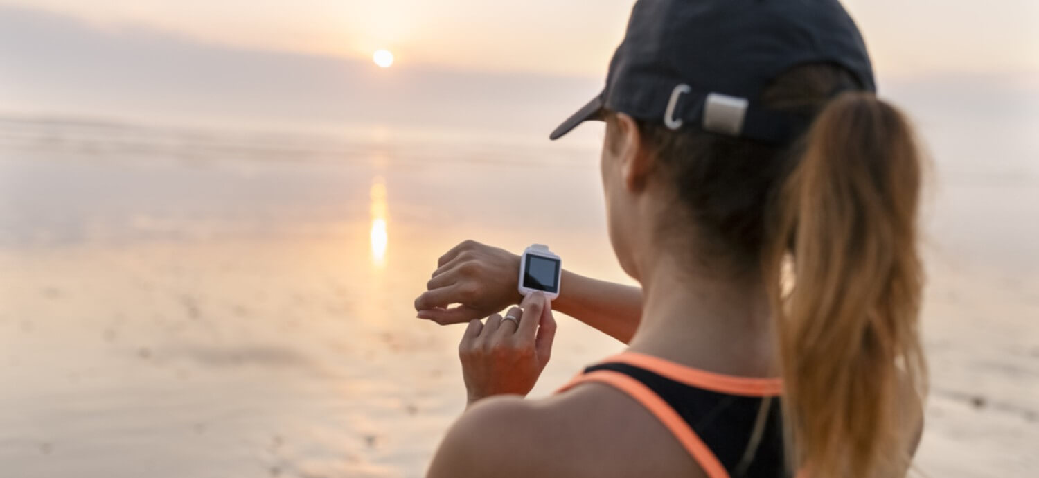 woman looking at sports watch