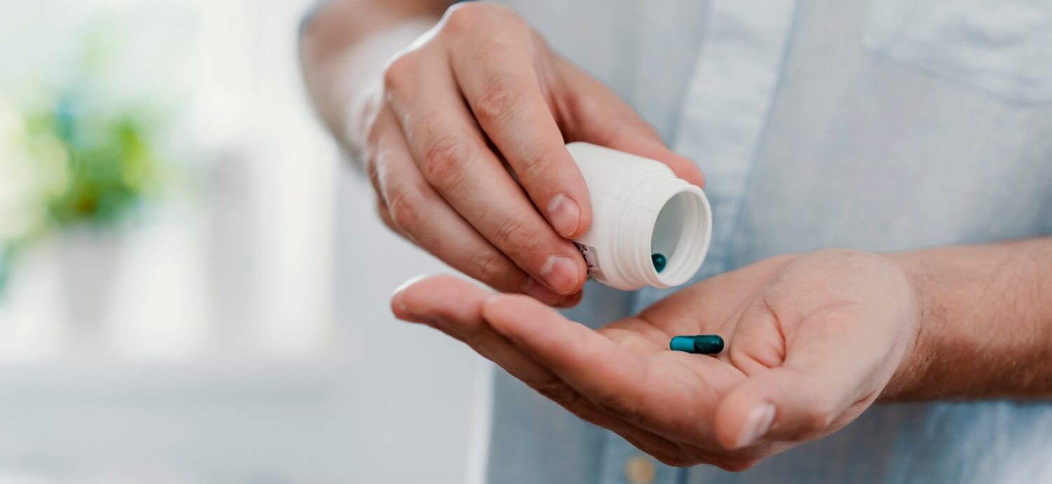 man taking a vitamin