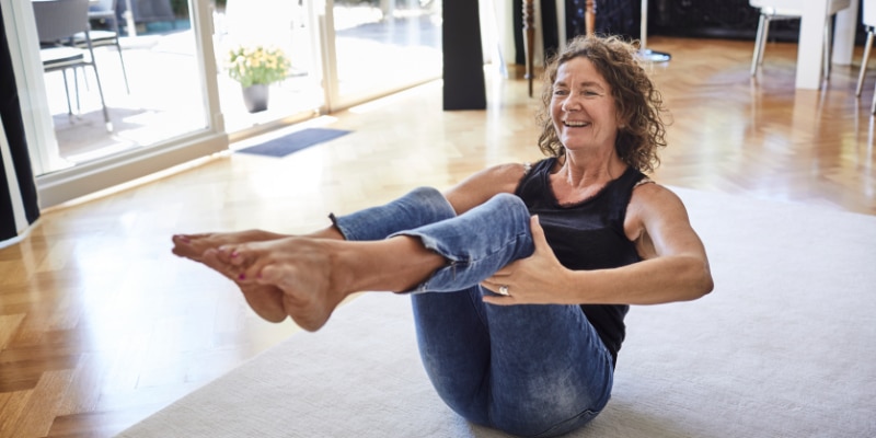 older female adult doing yoga and stretching