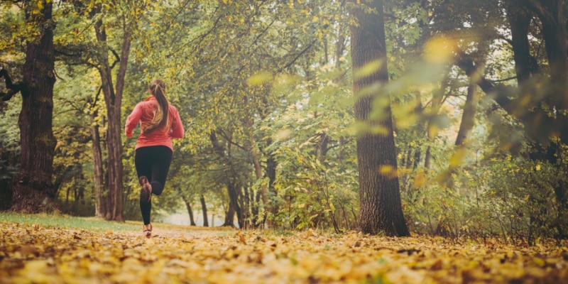 Woman running through the woods
