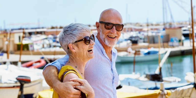 Senior couple wearing sunglasses to protect their eye health.