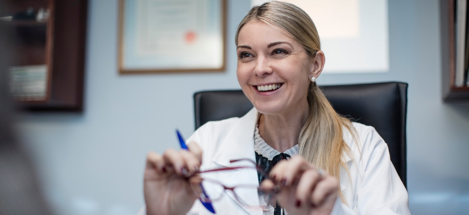 eye doctor holding glasses