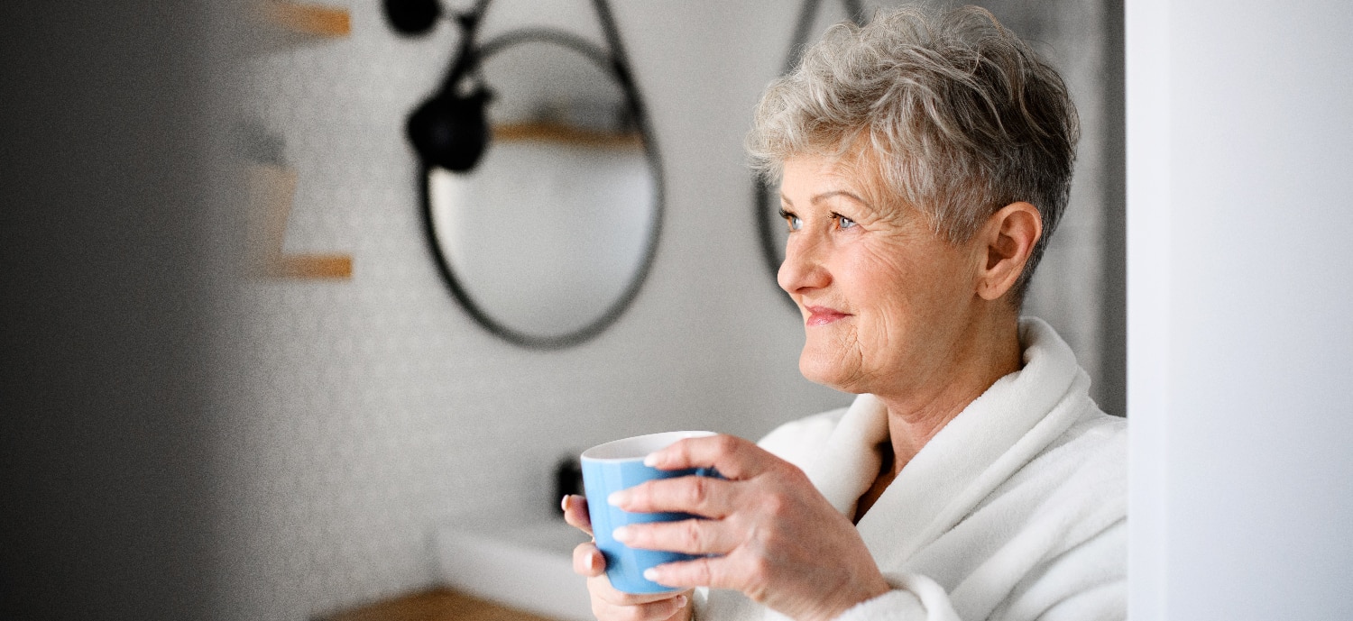 Woman drinking coffee as part of her successful morning routine
