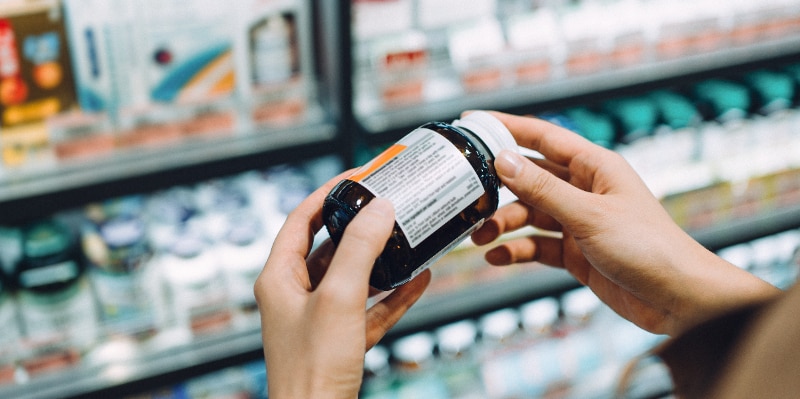 woman reading supplement label