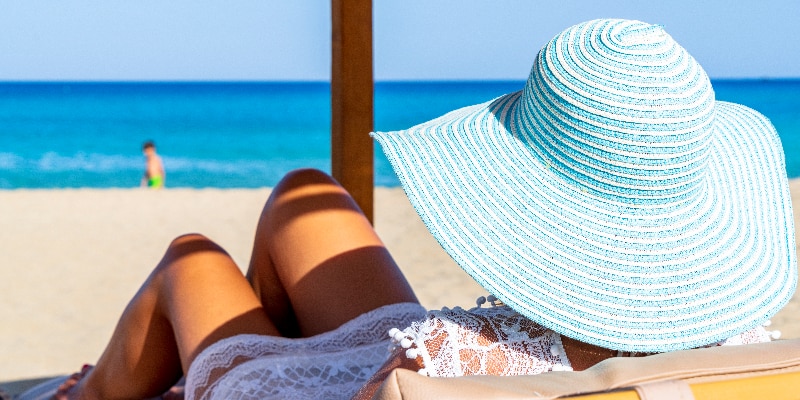 woman getting vitamin D on the beach in the sun