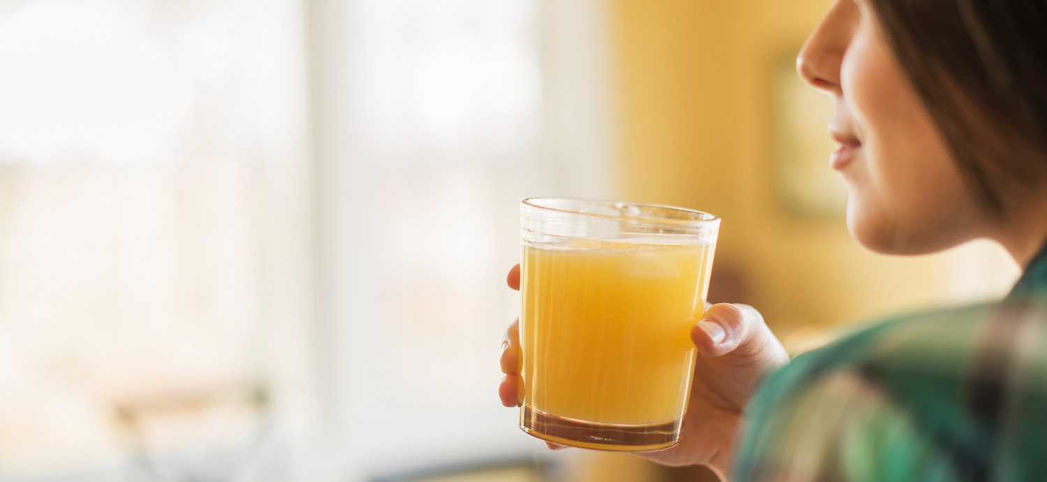 woman drinking orange juice liquid vitamin