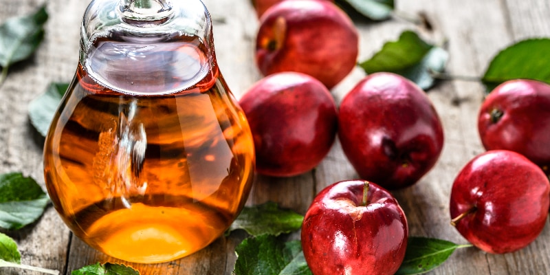 apples and apple cider vinegar on a table
