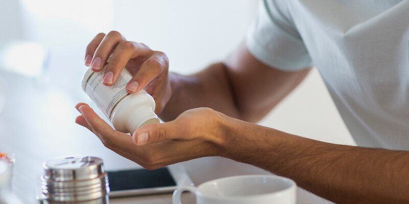 man taking vitamins