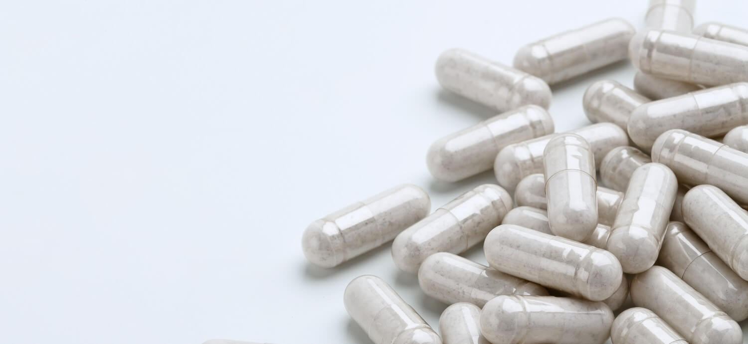 white vitamin capsules glucosamine
