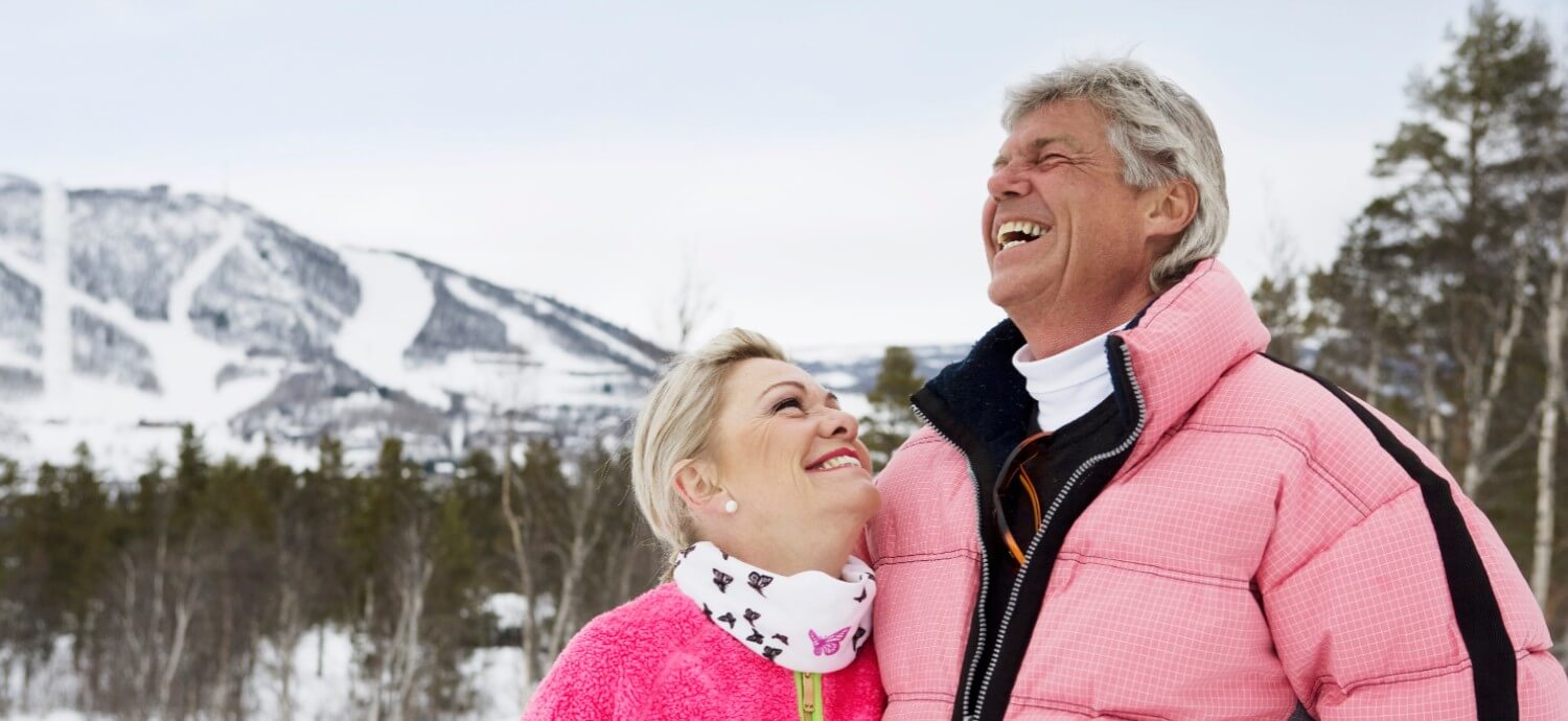 senior couple in the snow winter landscape