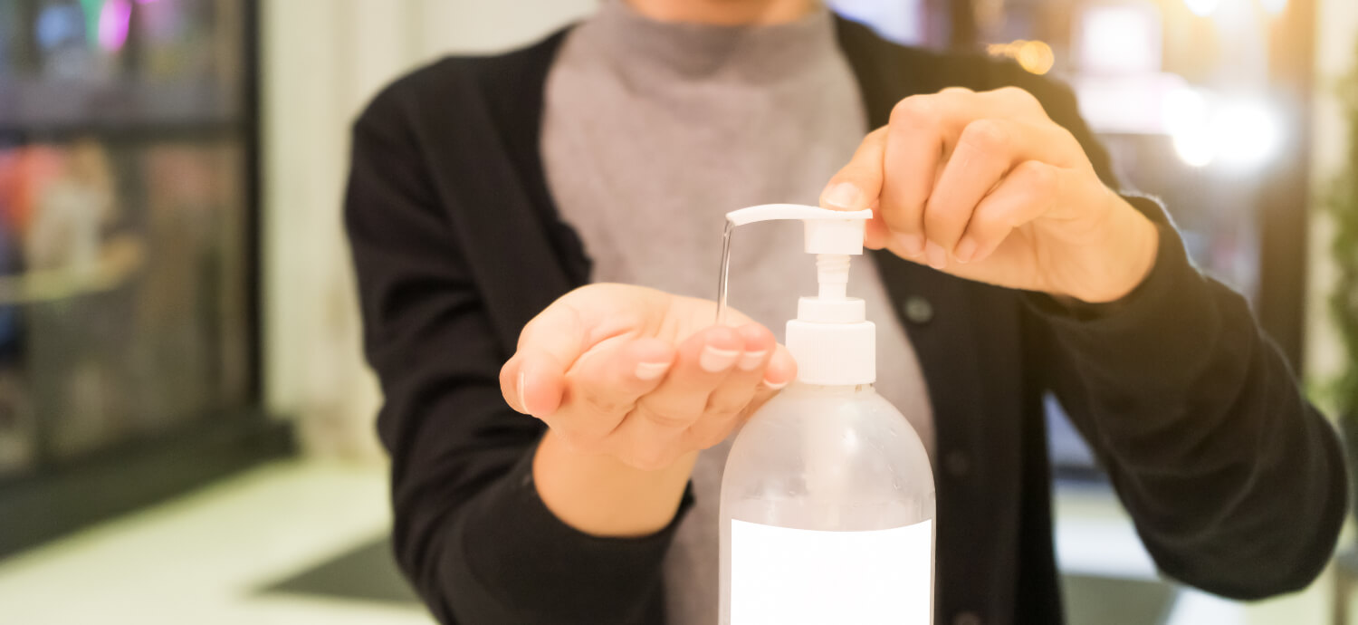 A woman using hand sanitizer